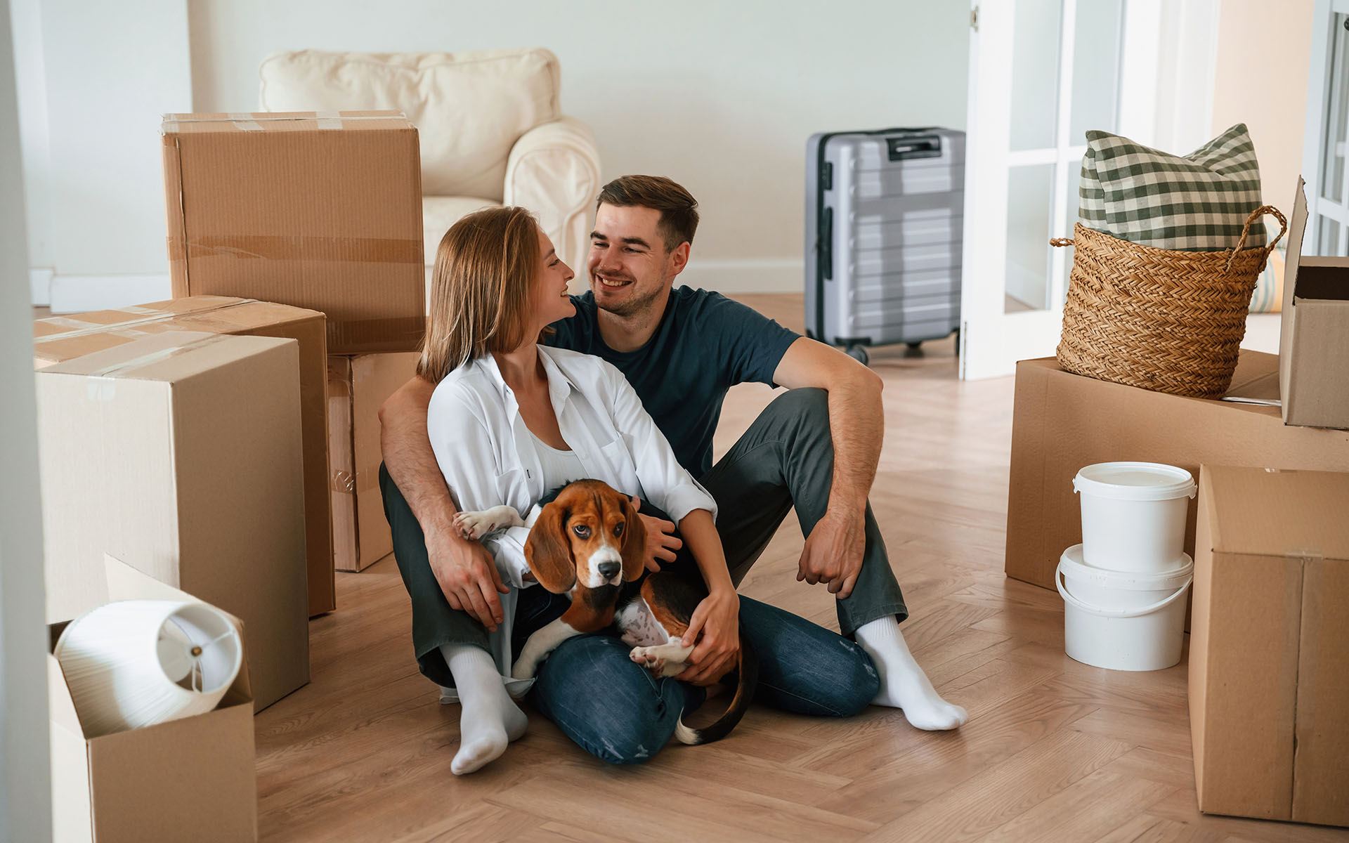 Young Couple With Dog Moving Into New Home